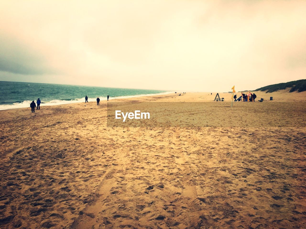 PEOPLE AT BEACH AGAINST SKY