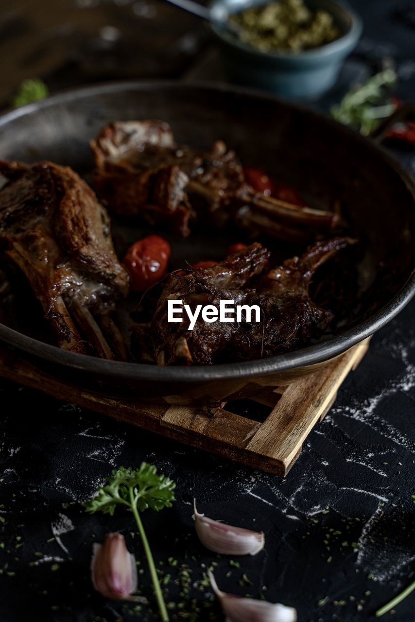 HIGH ANGLE VIEW OF MEAT IN COOKING PAN ON TABLE