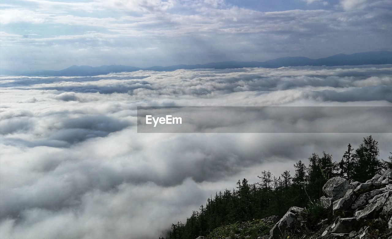 LOW ANGLE VIEW OF CLOUDS OVER MOUNTAIN