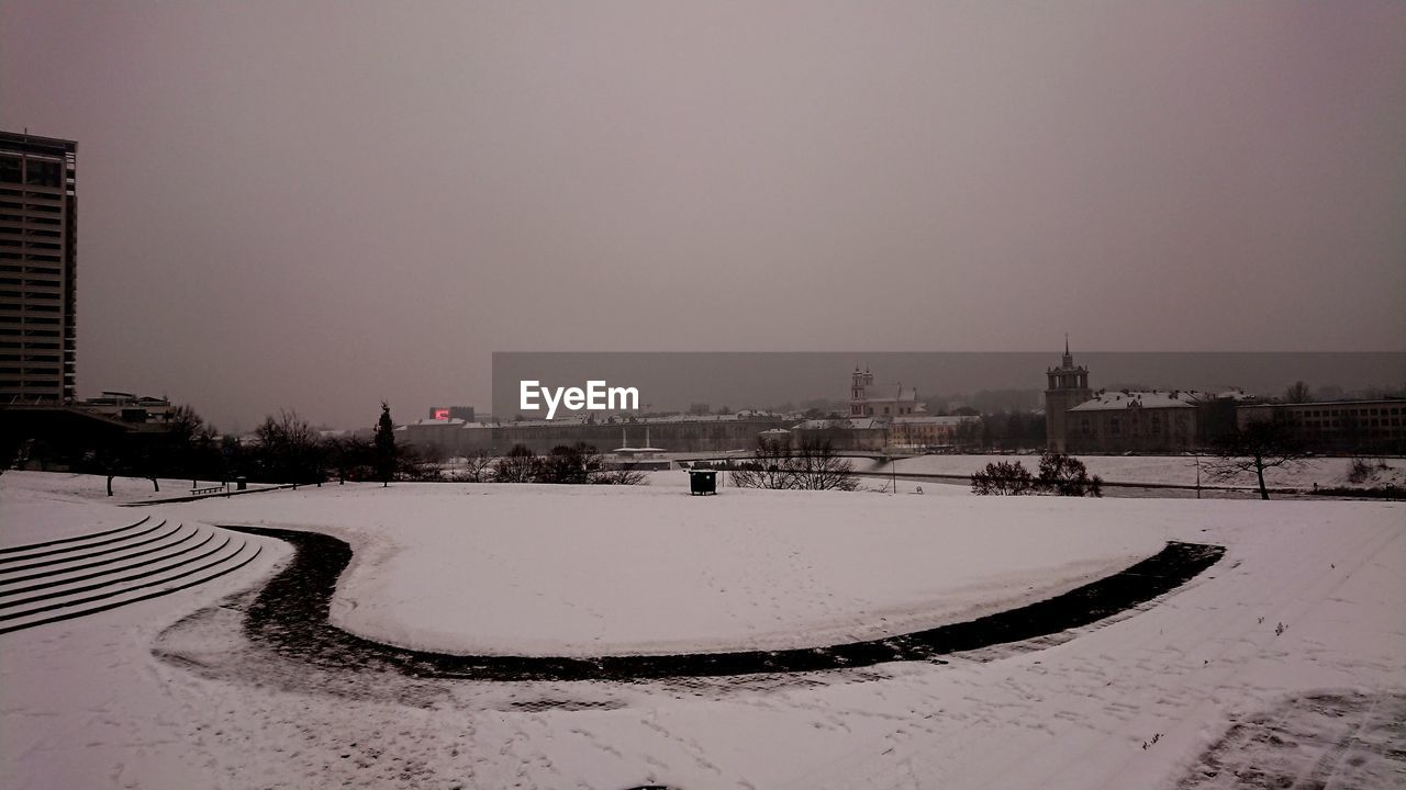 SNOW COVERED BUILDINGS AGAINST SKY