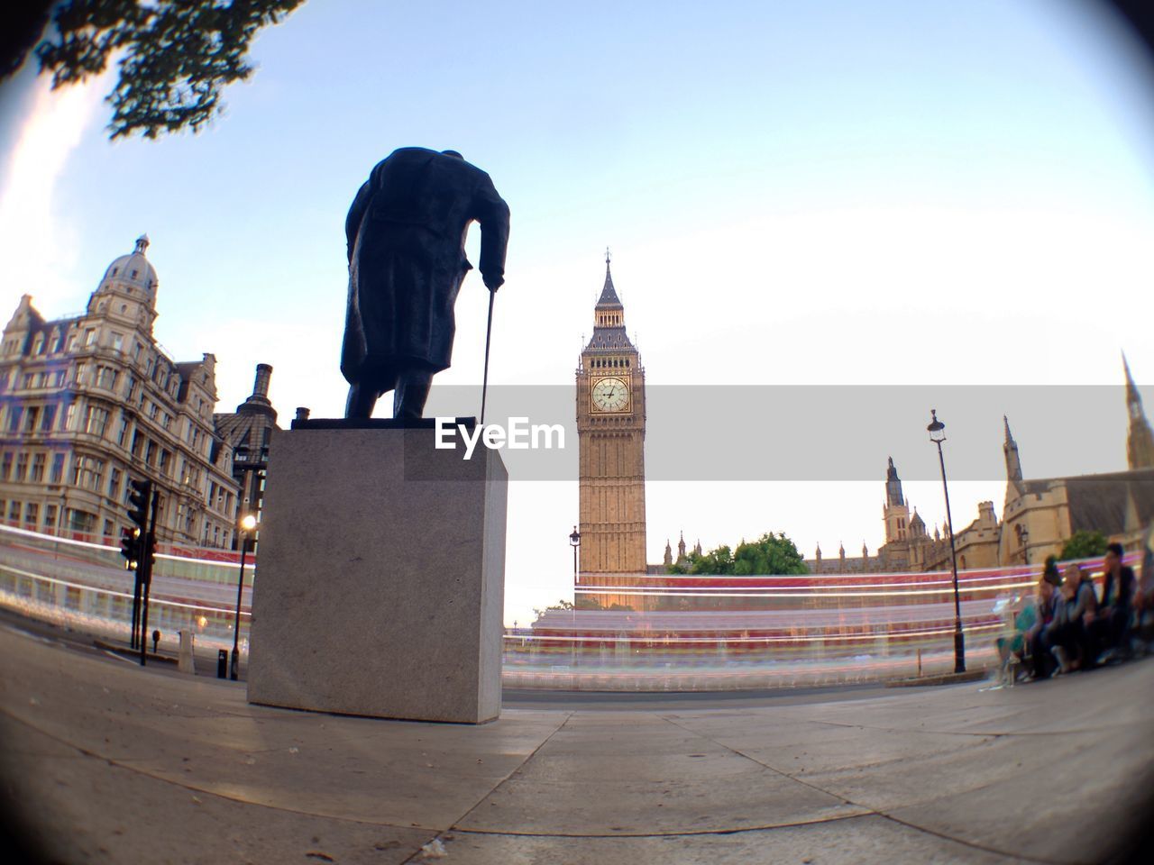 Light trails on road against big ben