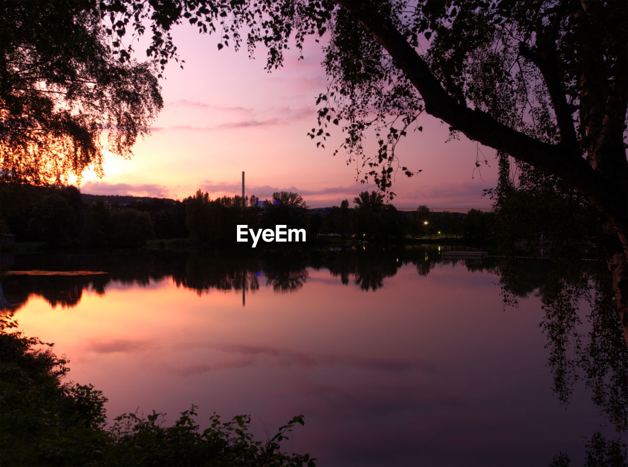 SCENIC VIEW OF LAKE AGAINST ORANGE SKY