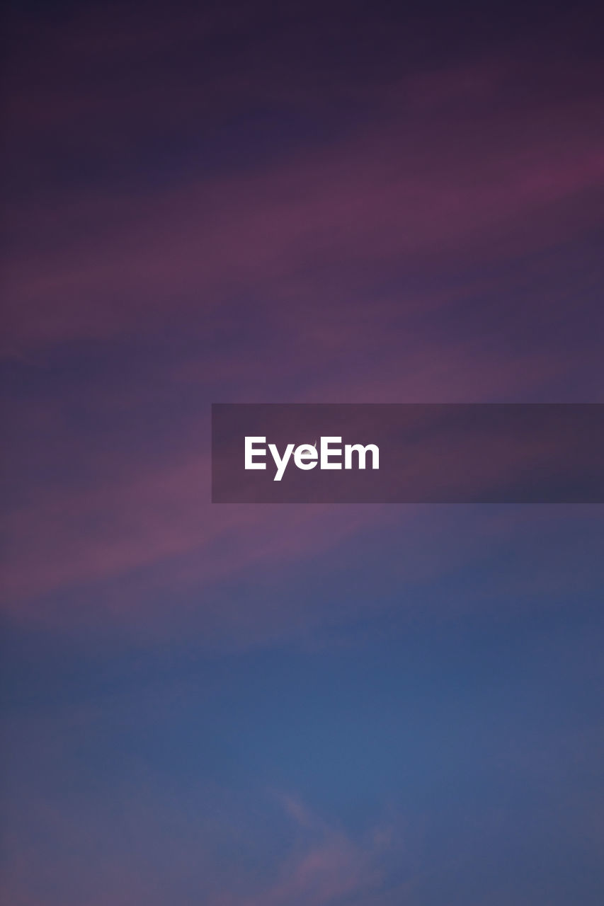 Sunset with pink clouds with crescent moon