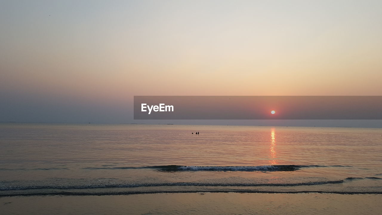 SCENIC VIEW OF SEA DURING SUNSET