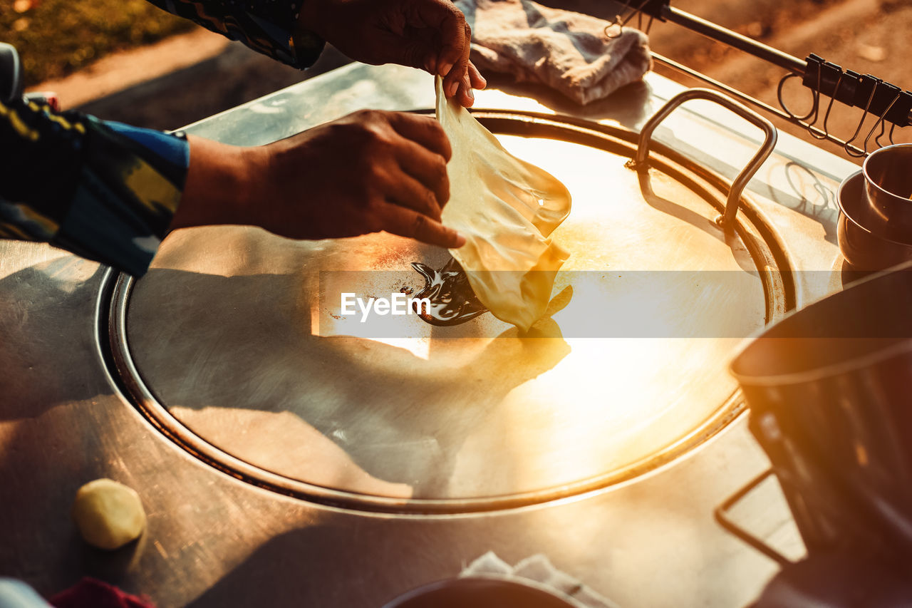 Cropped image of hand making roti