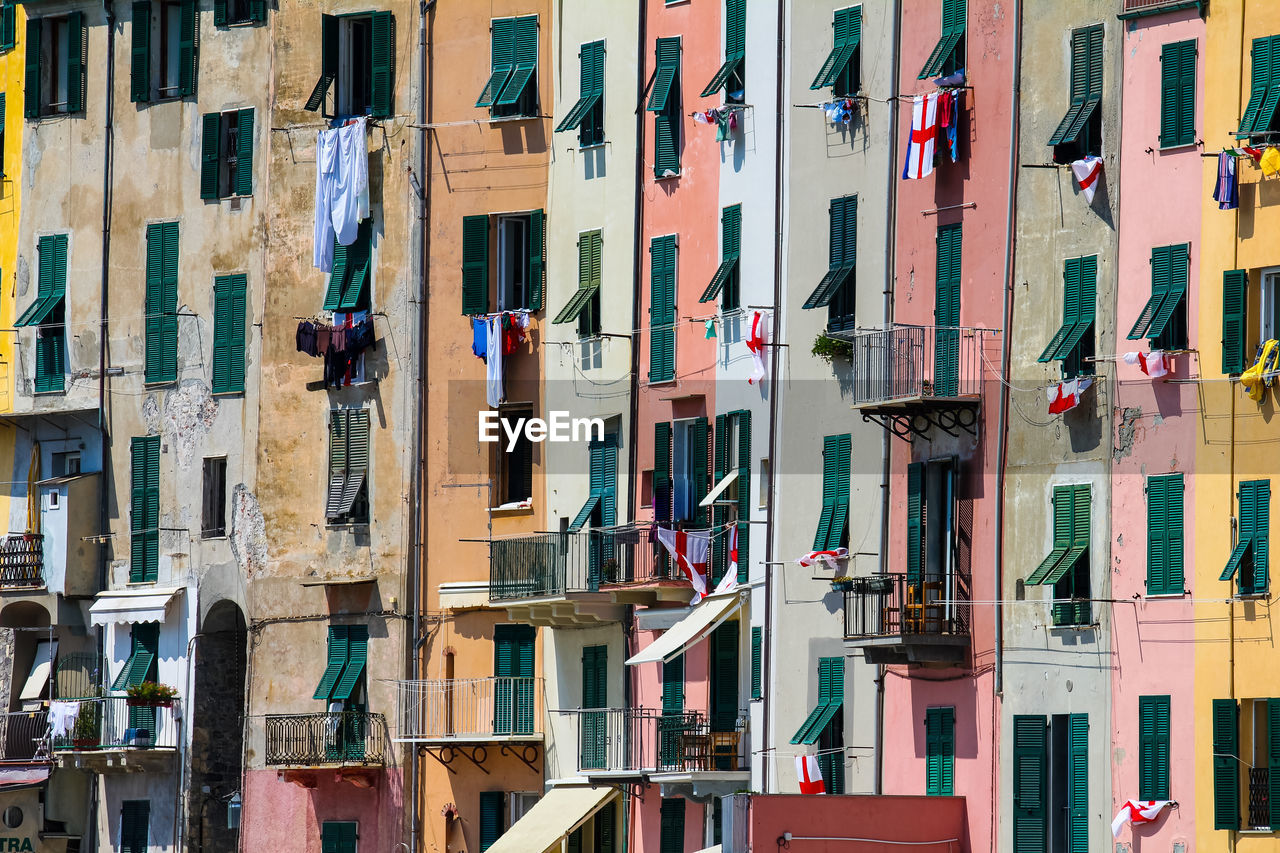 LOW ANGLE VIEW OF CLOTHES HANGING ON BUILDING