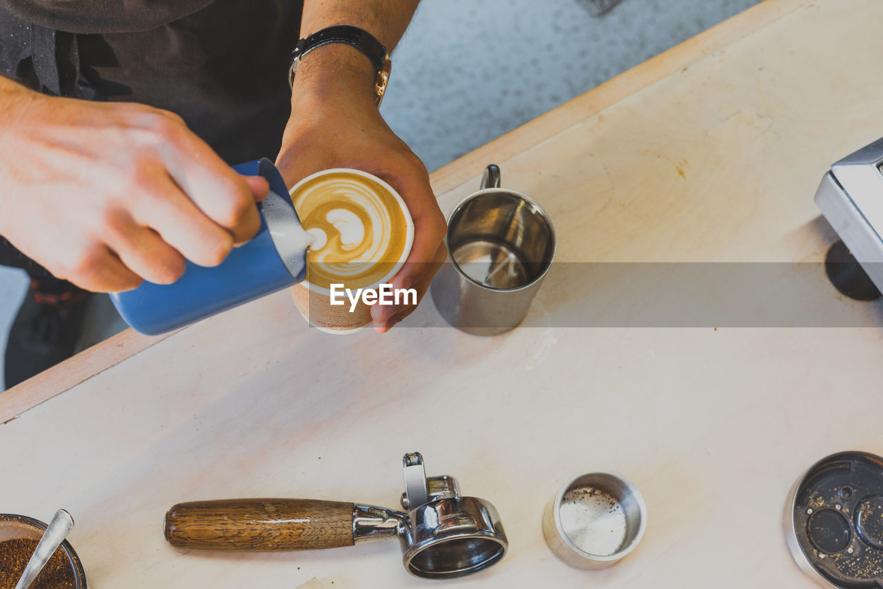 High angle view of person making coffee on table