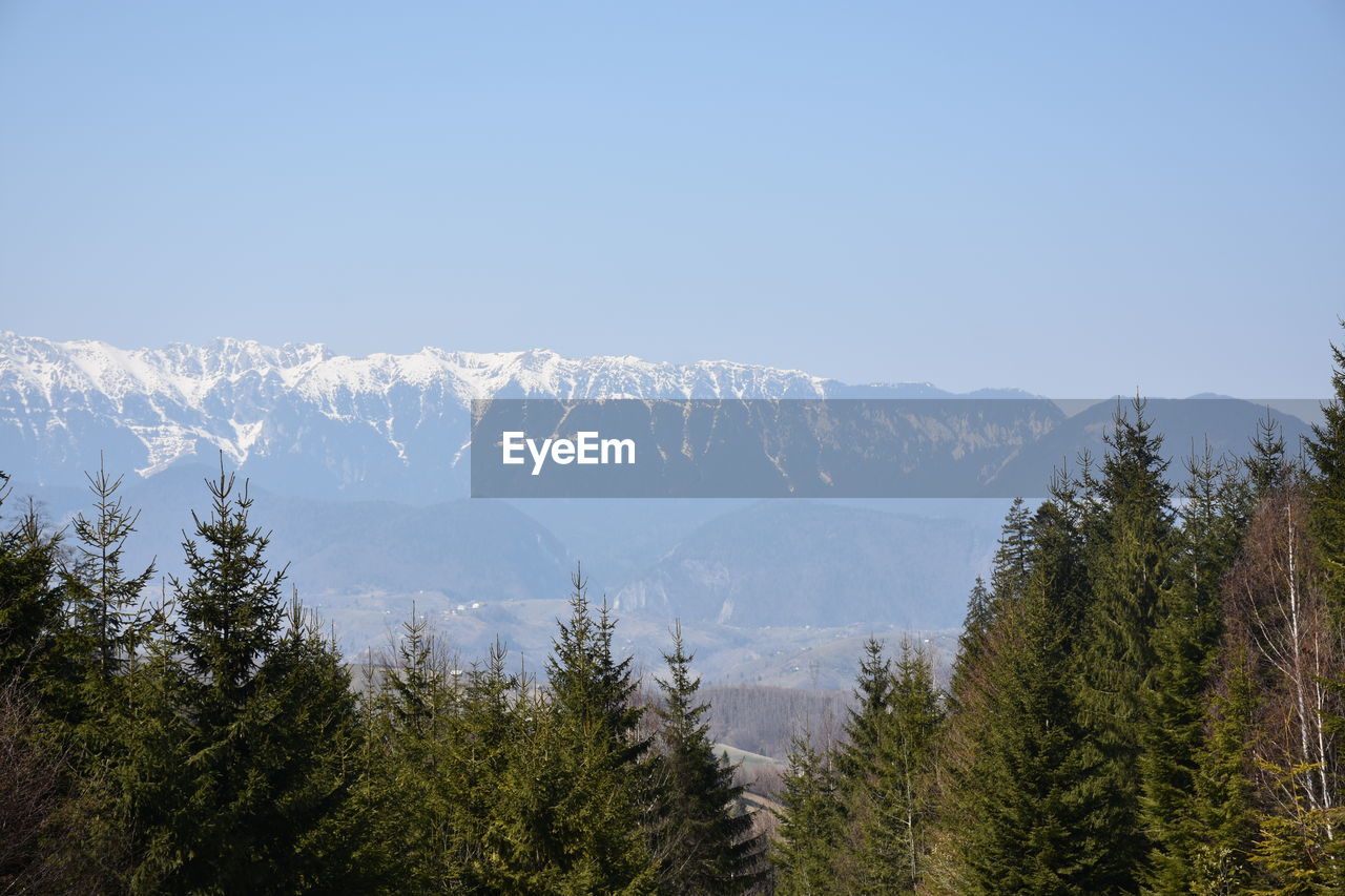 Scenic view of snowcapped mountains against clear sky