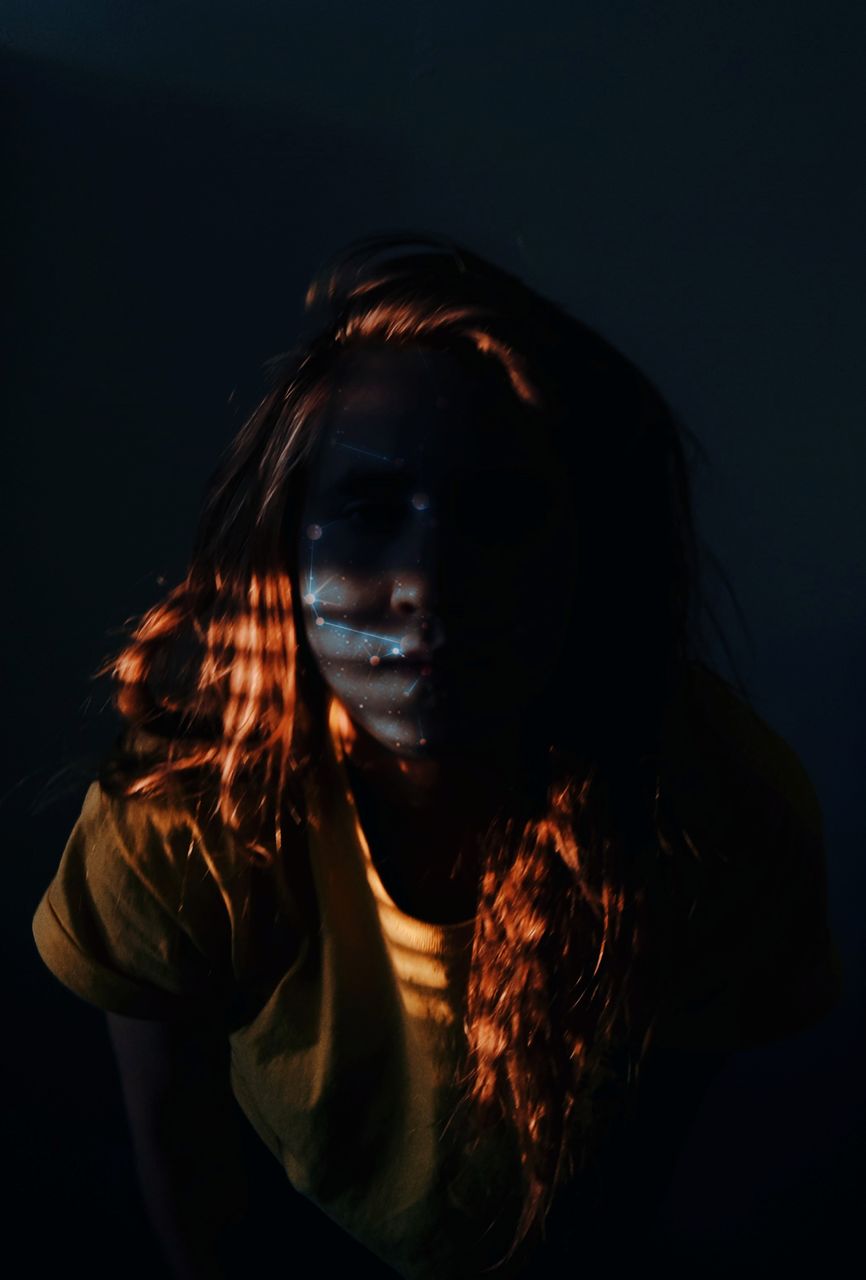 Portrait of young woman in darkroom