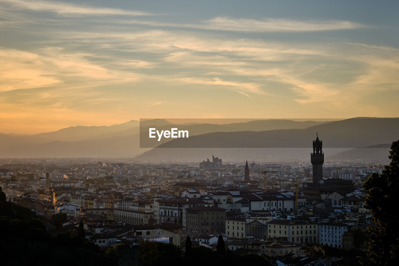 High angle shot of townscape against sky at sunset