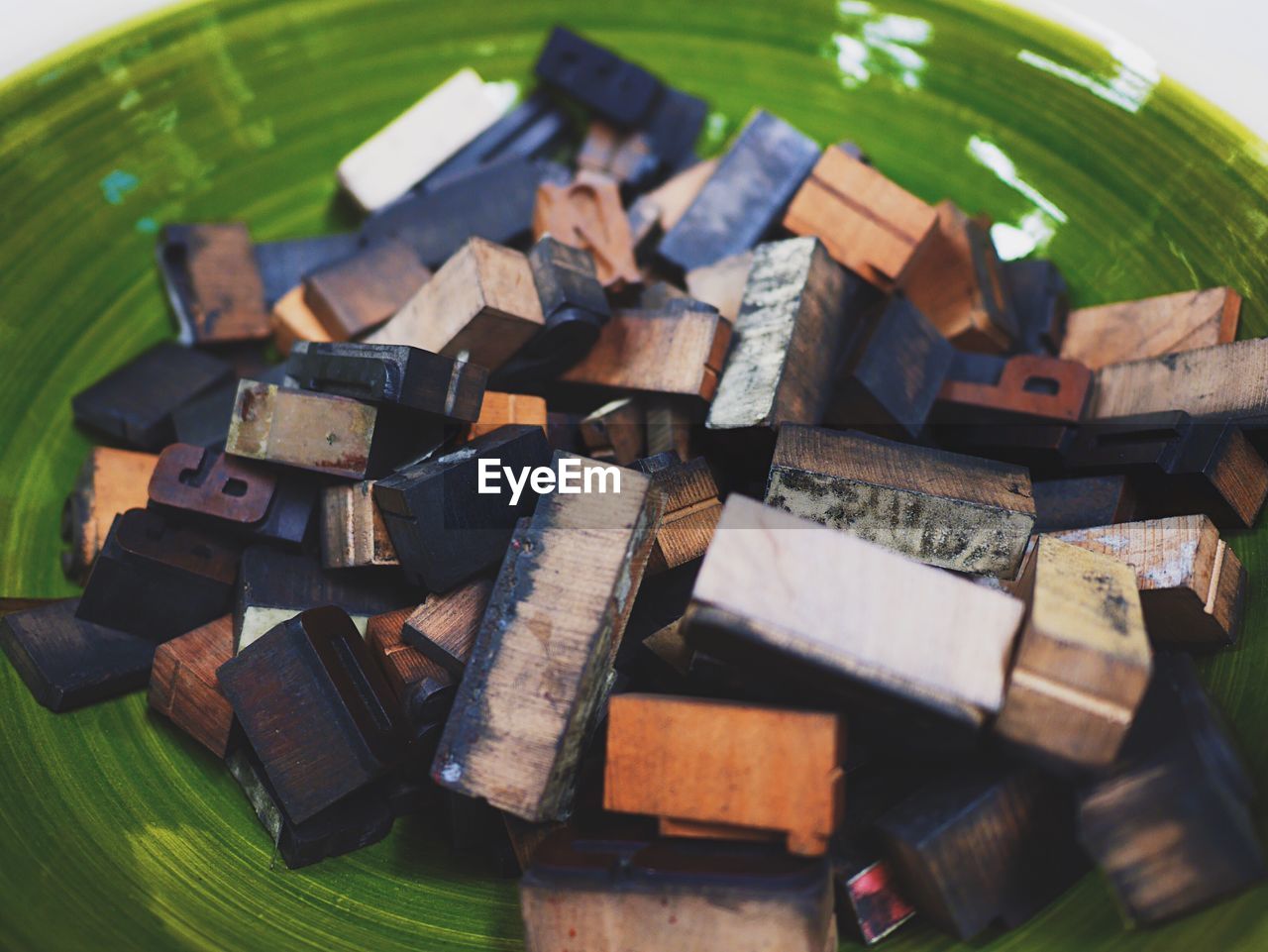 Close-up of alphabets on letterpress in plate