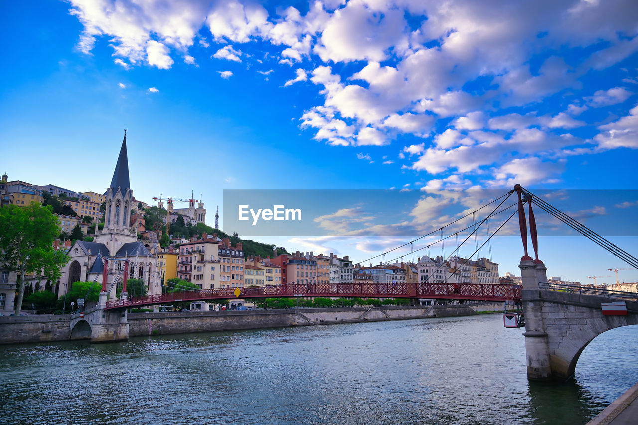 BRIDGE OVER RIVER AGAINST BUILDINGS