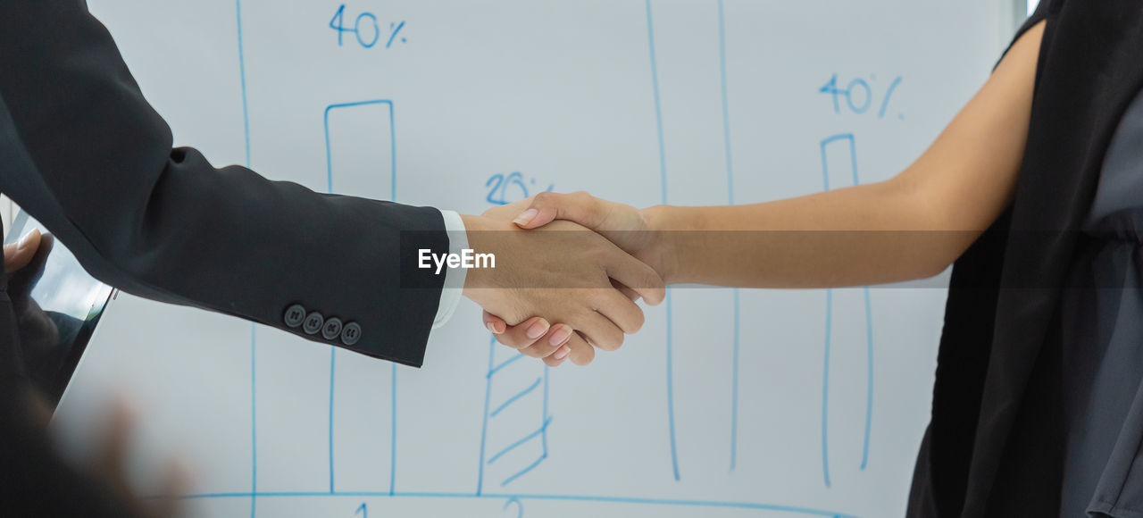 Businessman and businesswoman handshake agreement success connection partnership together. 