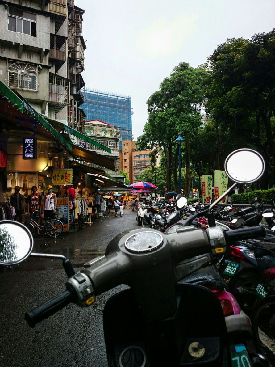 Motor scooters parked at street market