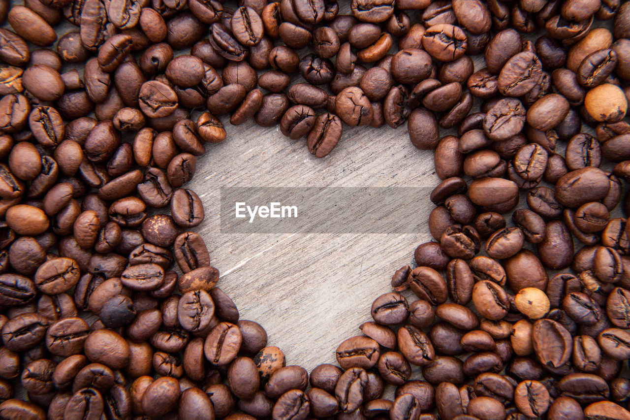 Close-up of heart shape roasted coffee beans on table