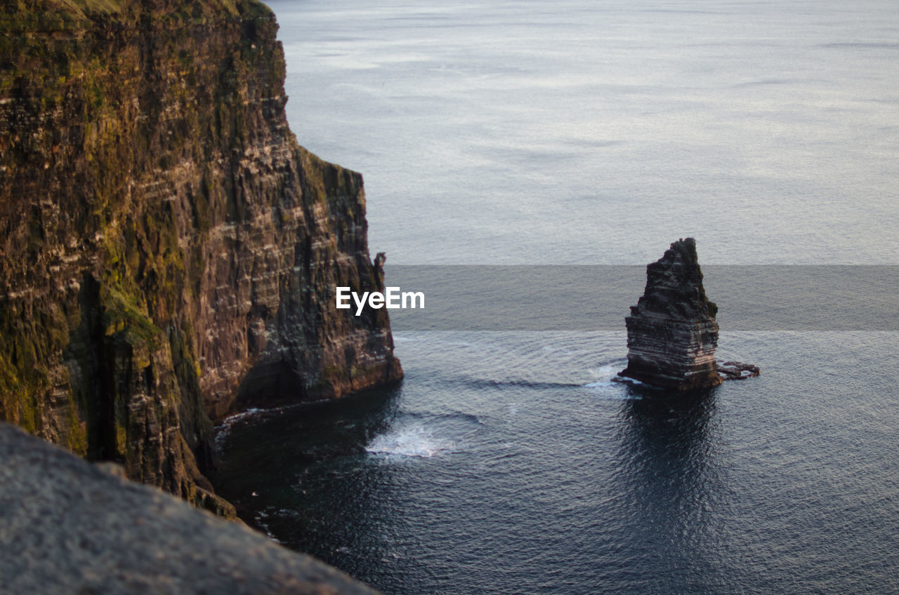 High angle view of cliff by sea