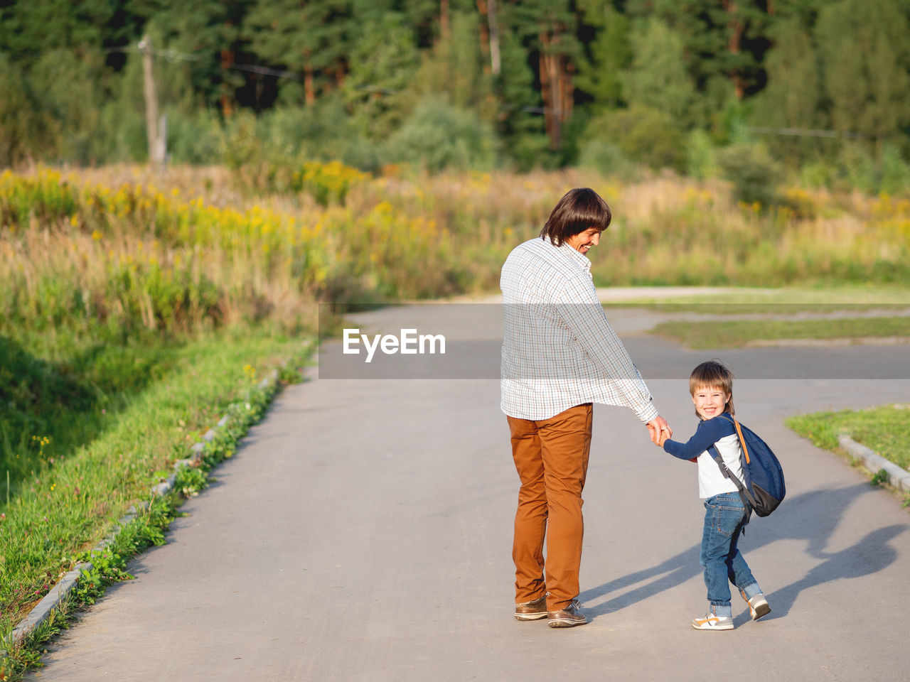 Father takes his son to school. back to school after summer holidays. family time, moral support.