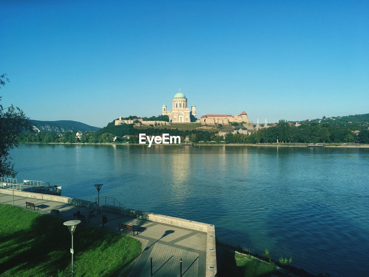 BUILDINGS AGAINST CLEAR BLUE SKY WITH WATERFRONT