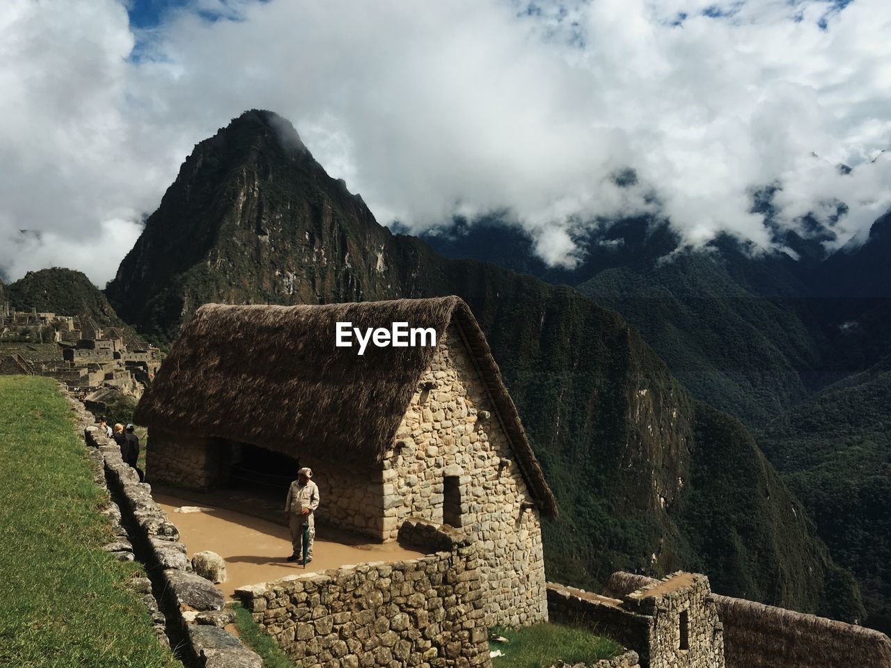 WOMAN STANDING IN FRONT OF MOUNTAIN RANGE