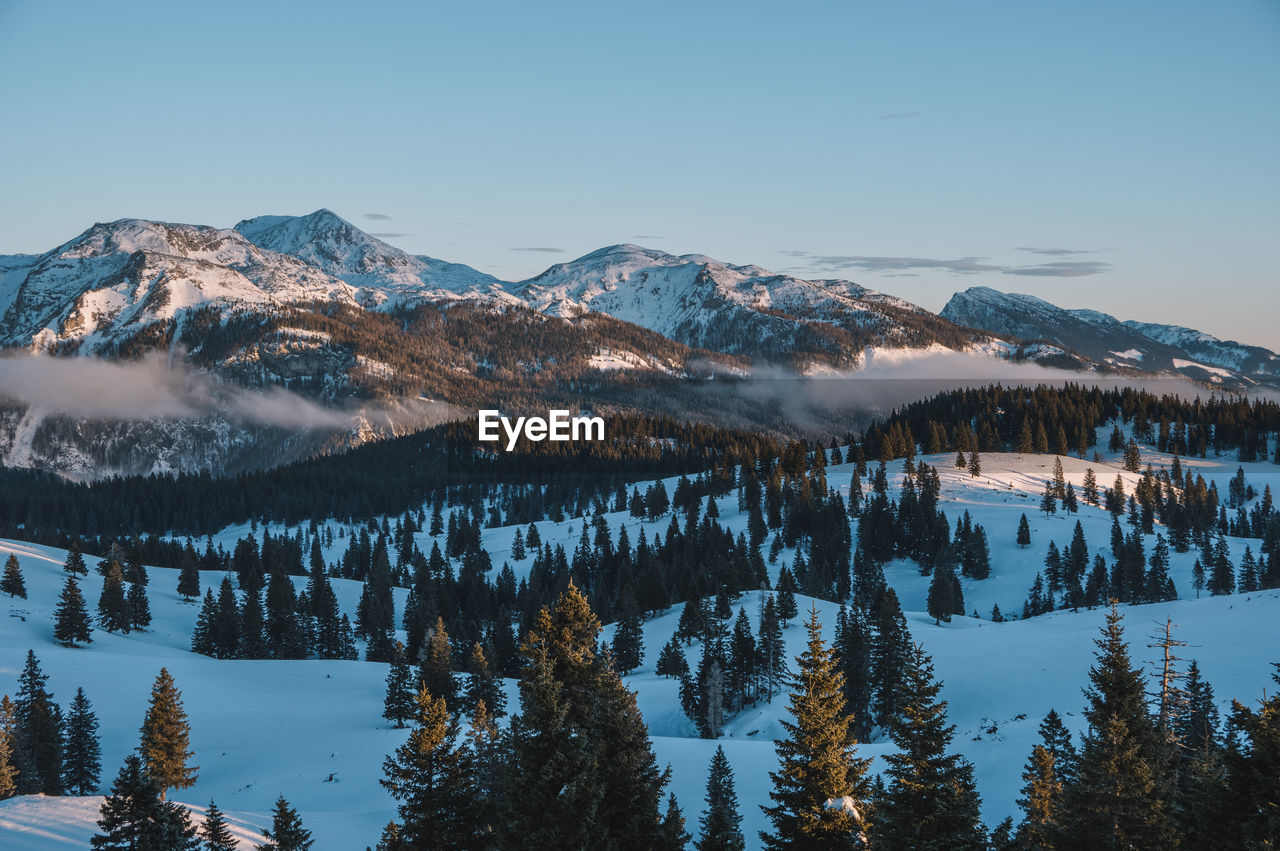 Scenic view of snow capped mountains against clear sky