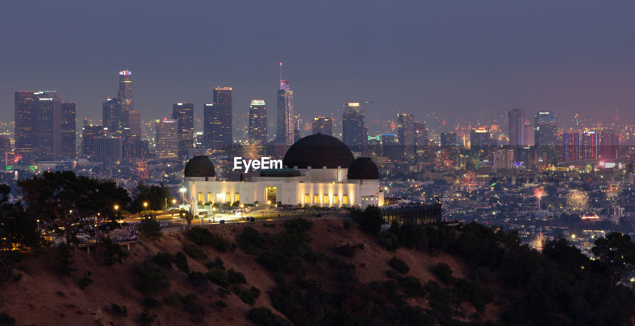 Fourth of july fireworks over griffith observatory with the los angeles skyline in the distance