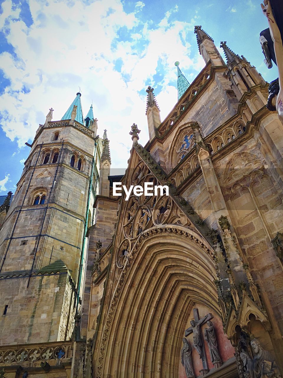 Low angle view of erfurt cathedral against cloud sky
