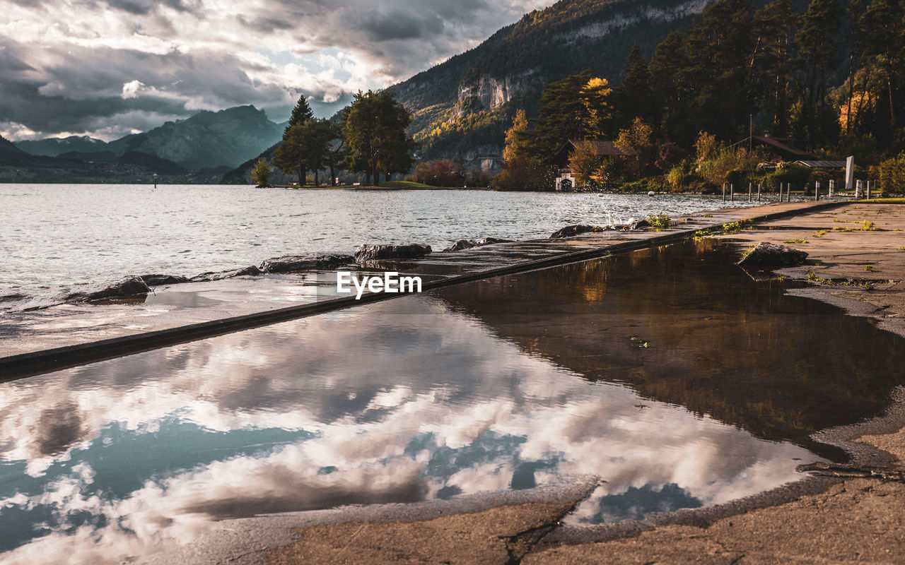 Scenic view of lake and mountains against sky