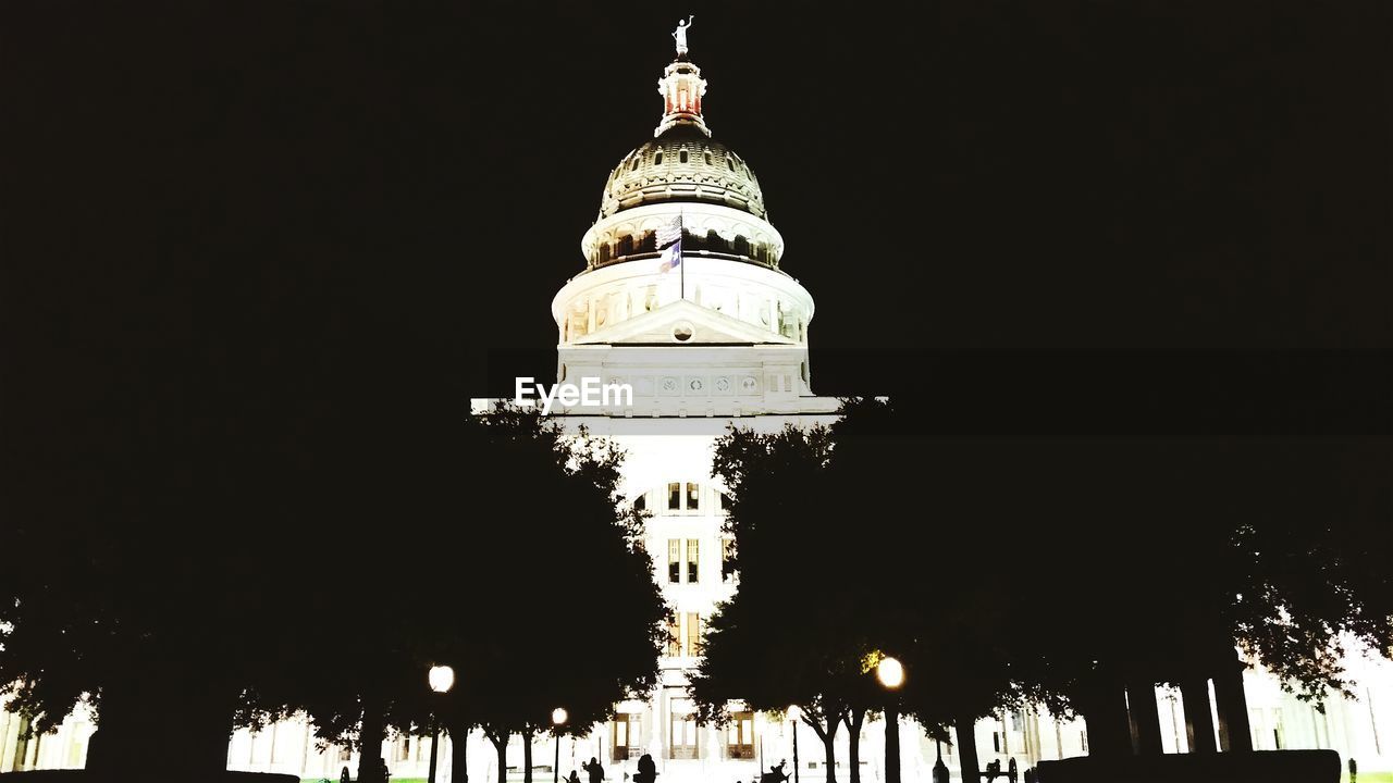 LOW ANGLE VIEW OF TOWER AT NIGHT