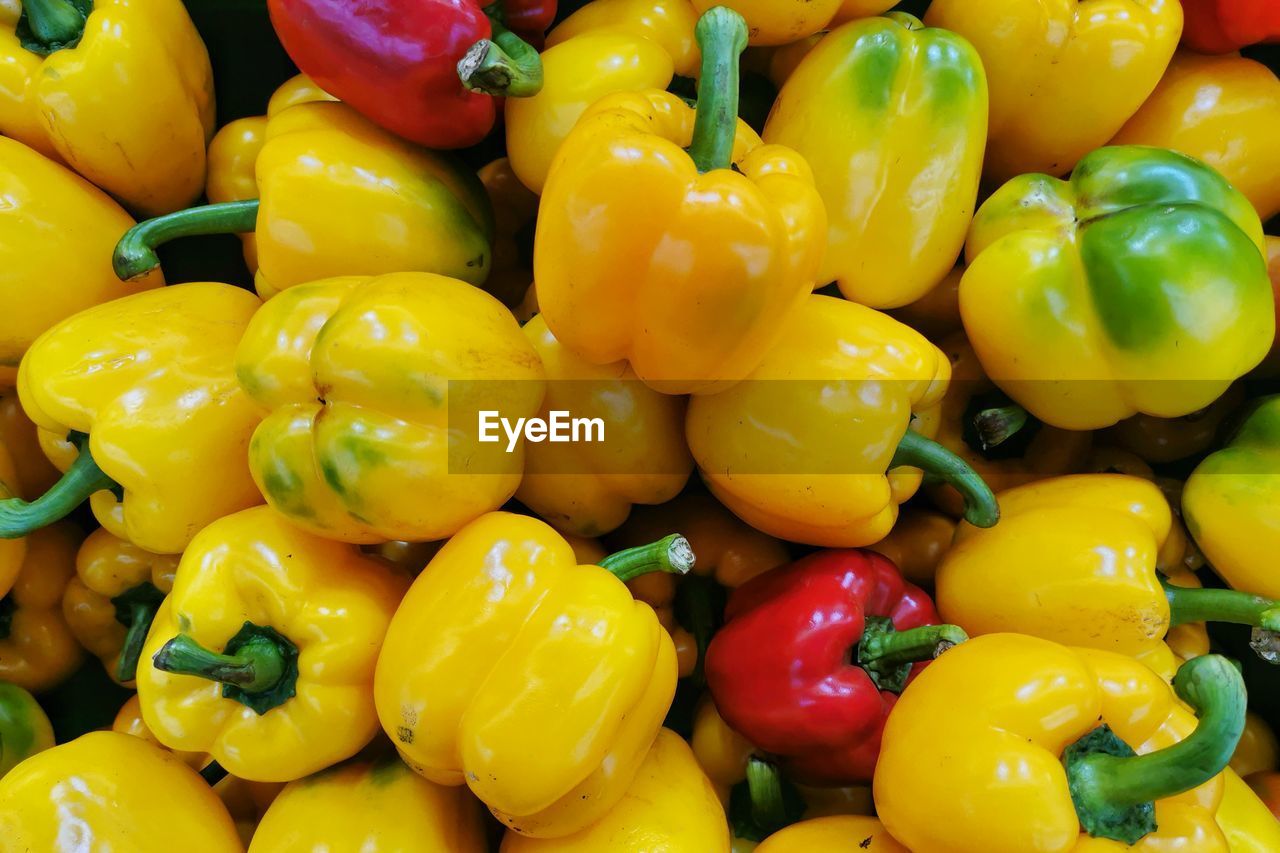 Full frame shot of yellow bell peppers for sale in market