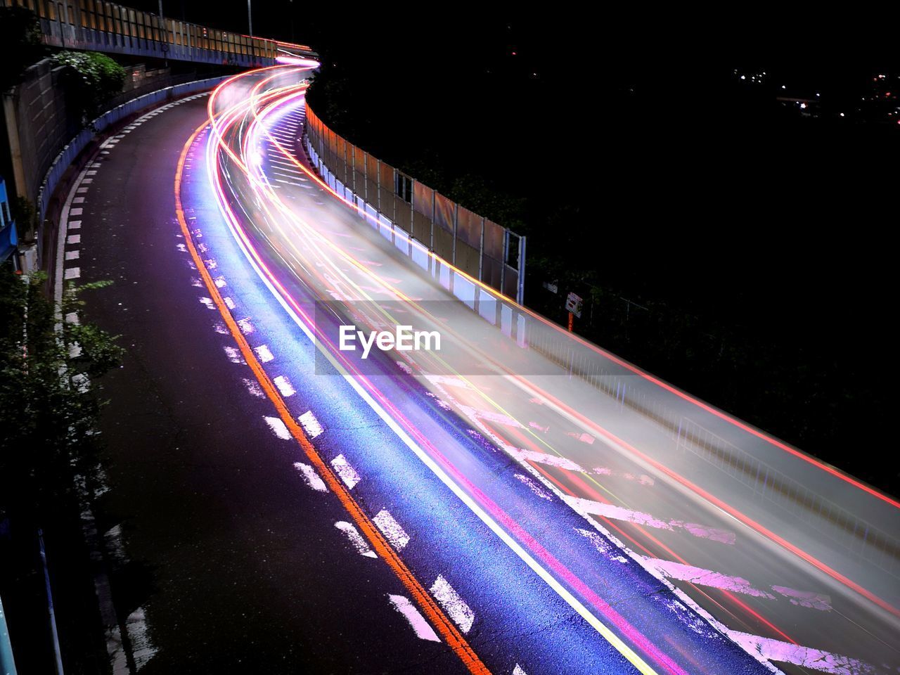 HIGH ANGLE VIEW OF LIGHT TRAILS ON ROAD