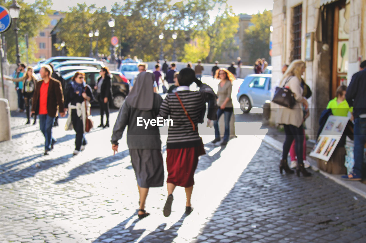 PEOPLE LOOKING AT CITY STREET