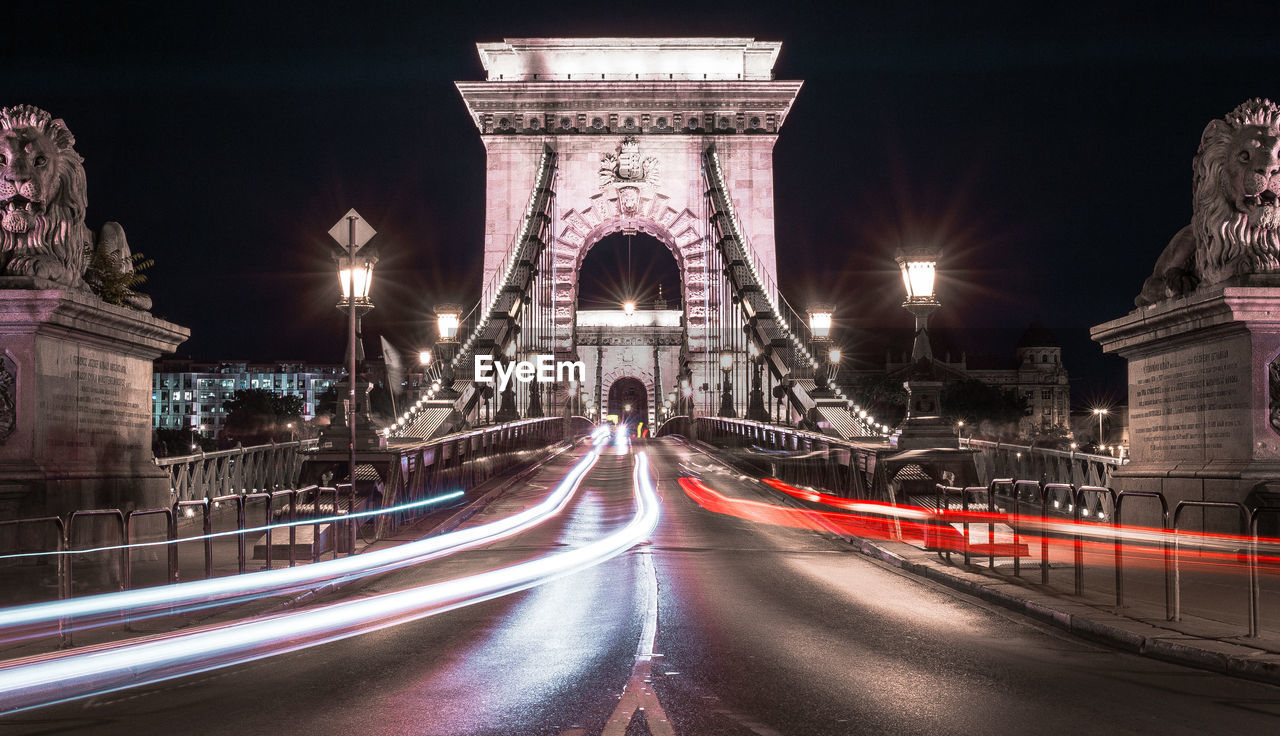 LIGHT TRAIL ON ROAD AT NIGHT