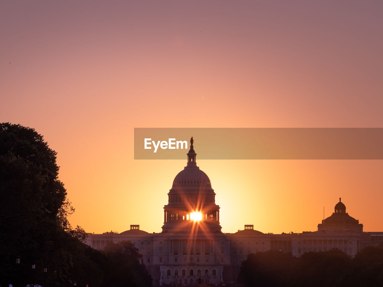 Silhouette building against sky during sunset