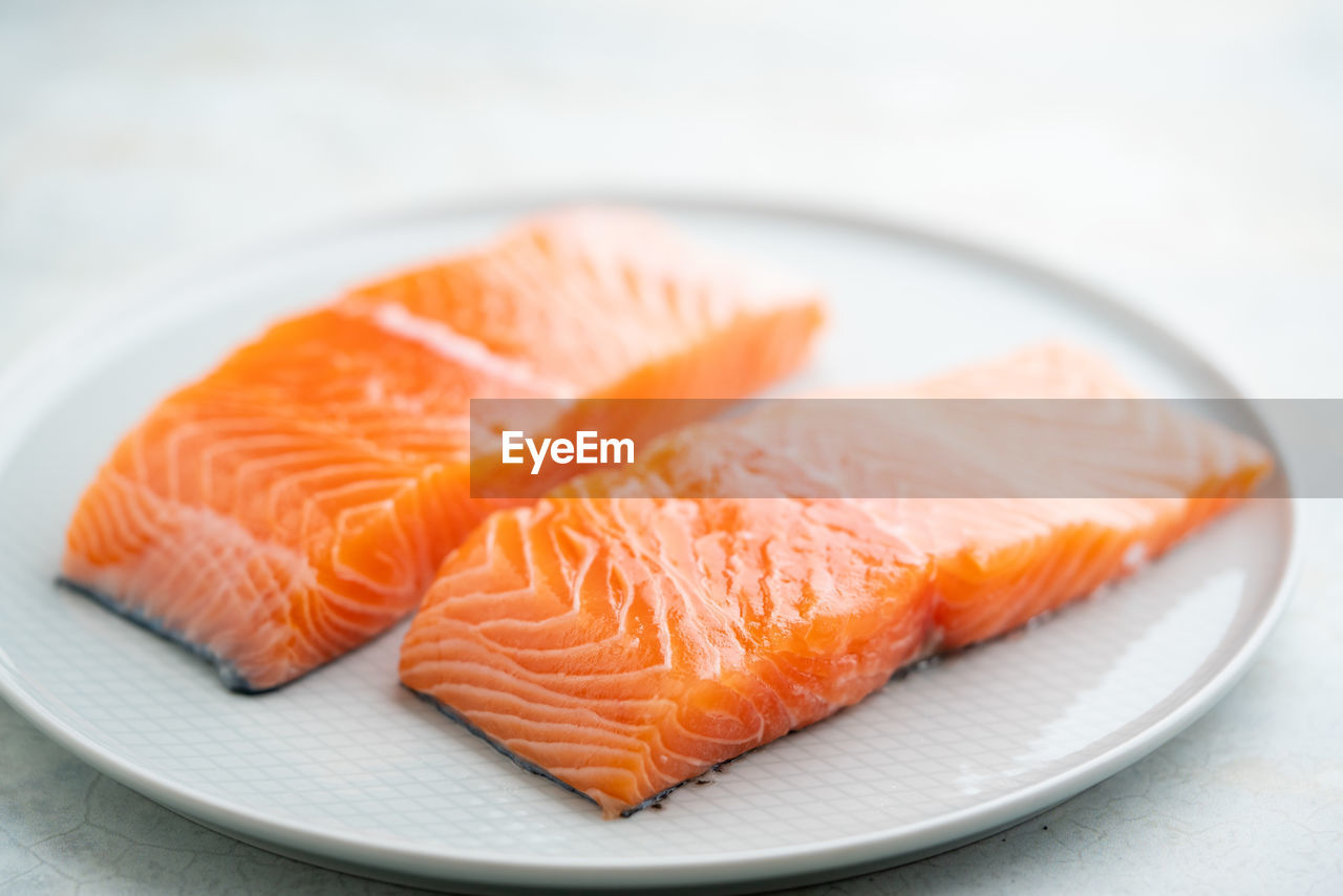 Fresh salmon fillet on a plate for delicious salmon steak.