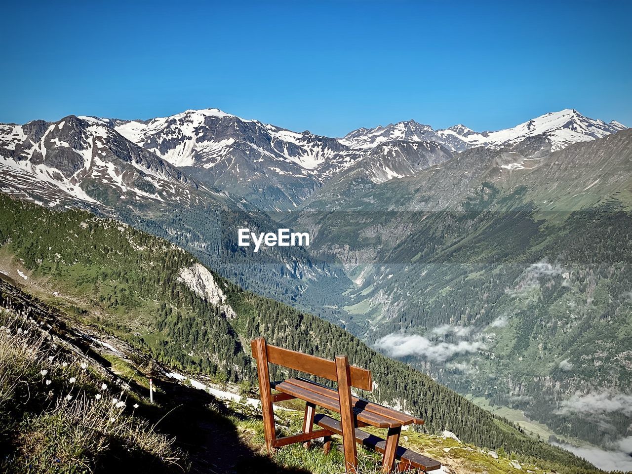 Scenic view of snowcapped mountains against blue sky