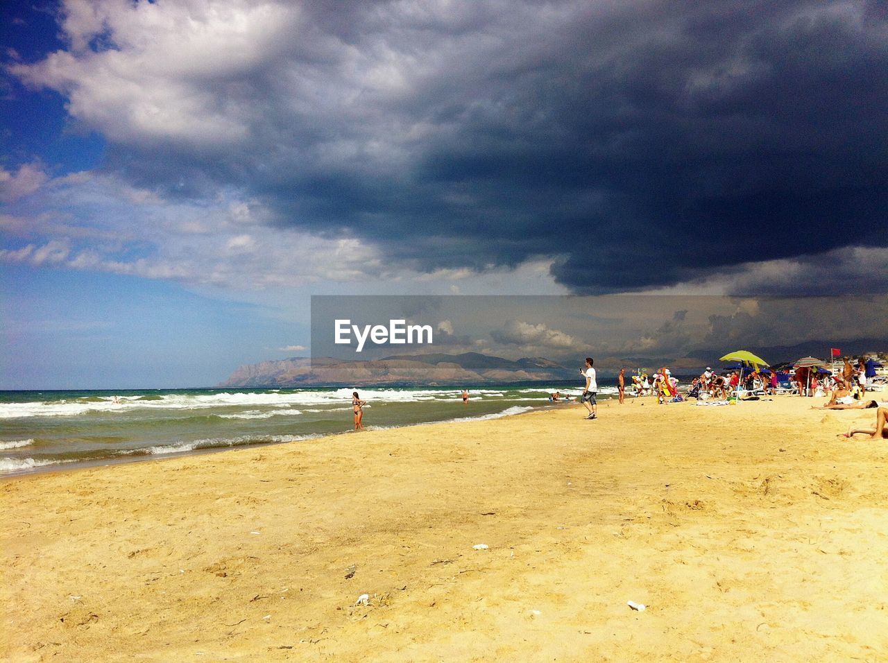 VIEW OF PEOPLE ON BEACH AGAINST SKY