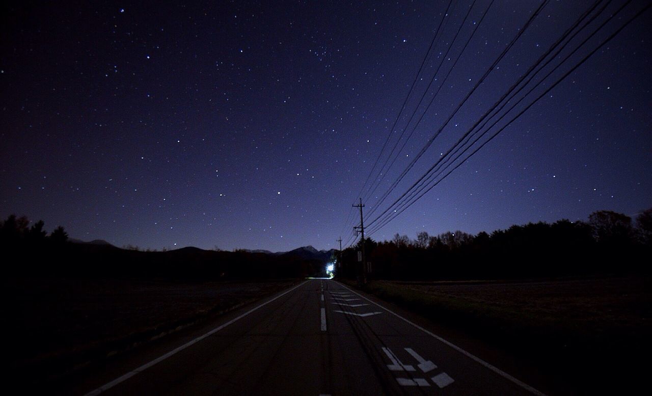 VIEW OF ROAD AGAINST CLEAR SKY AT NIGHT
