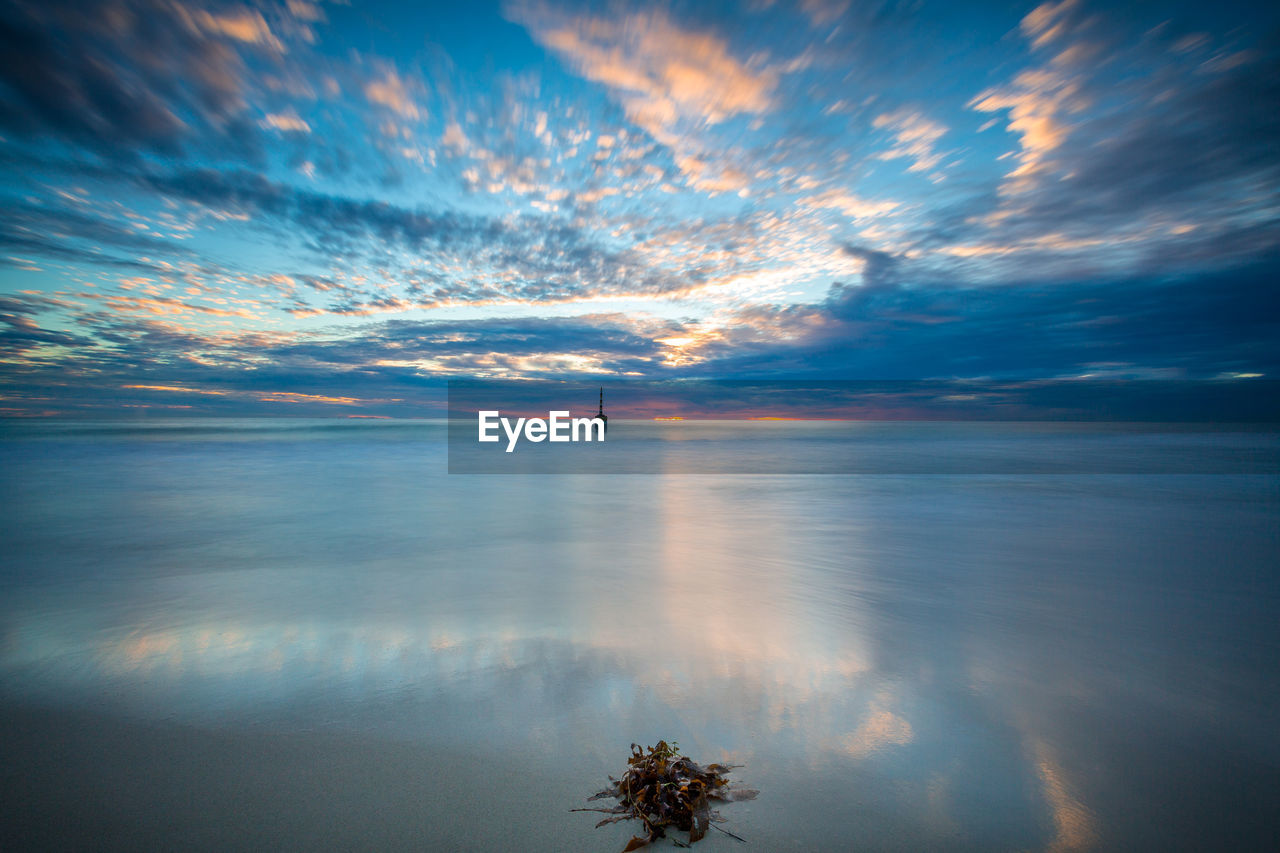 Scenic view of sea against sky at sunset