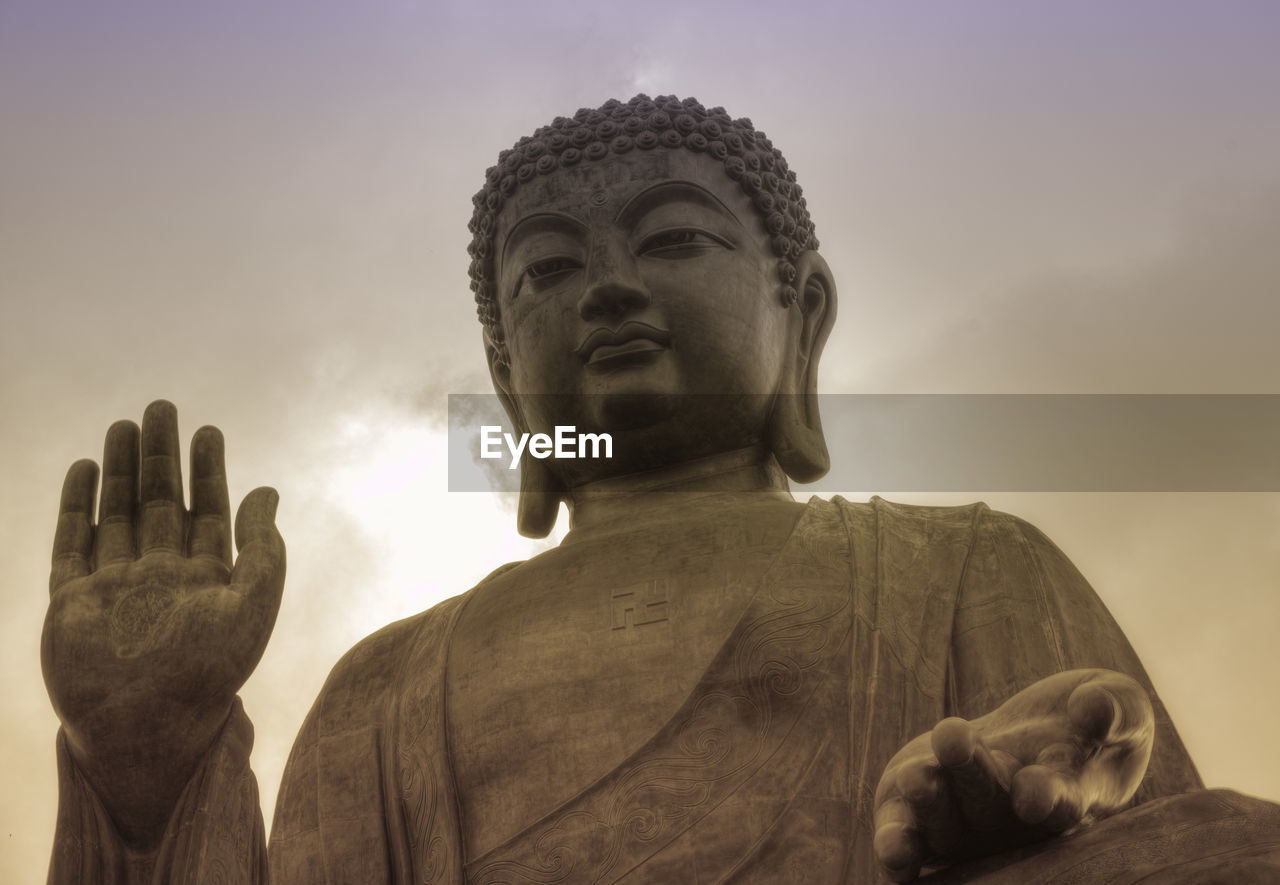 LOW ANGLE VIEW OF STATUE OF BUDDHA AGAINST SKY