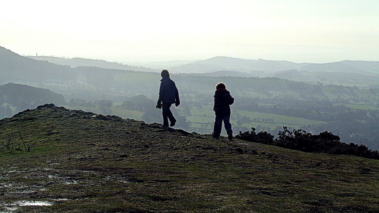 MEN WALKING ON MOUNTAIN ROAD