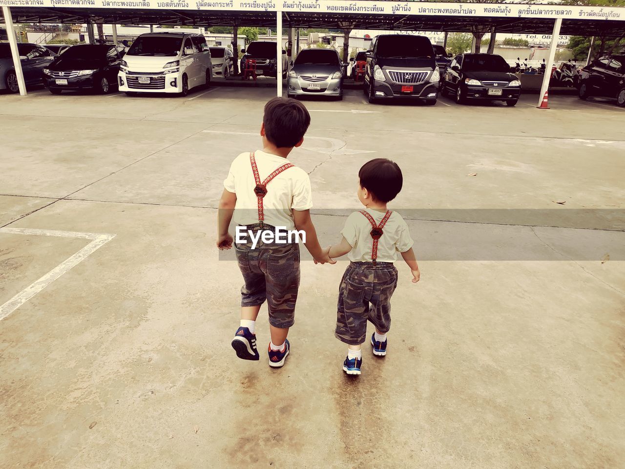 REAR VIEW OF CHILDREN ON STREET