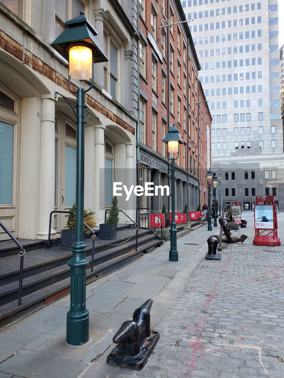 PEOPLE ON STREET AMIDST BUILDINGS