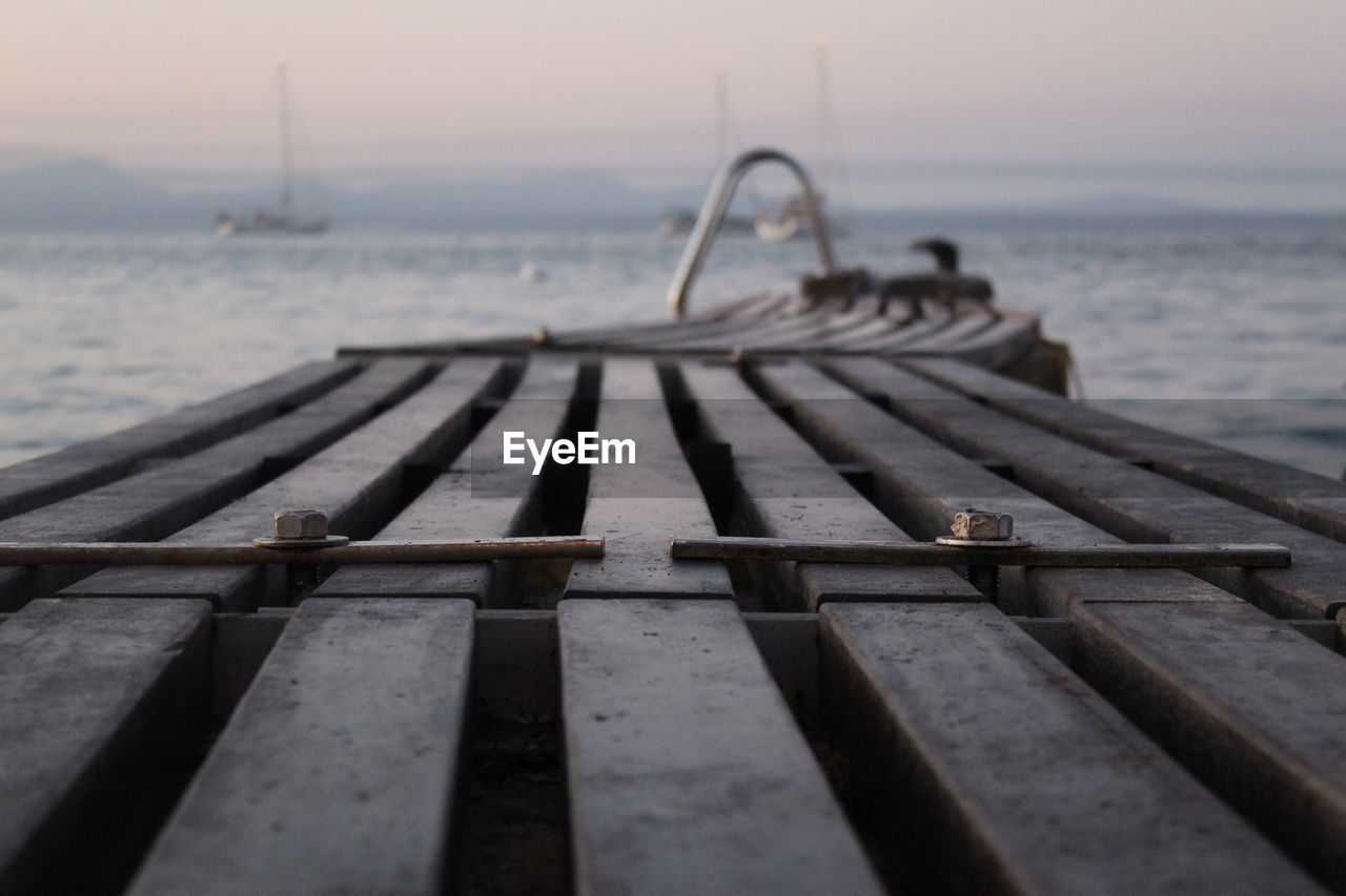 Pier over sea against sky during sunset 