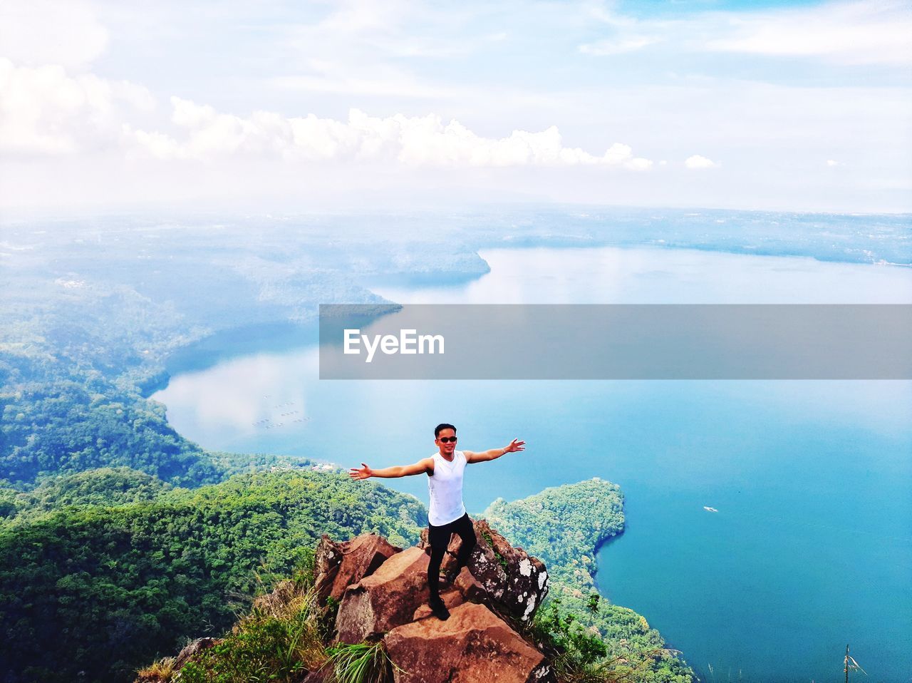 Man standing on rock looking at view of sky