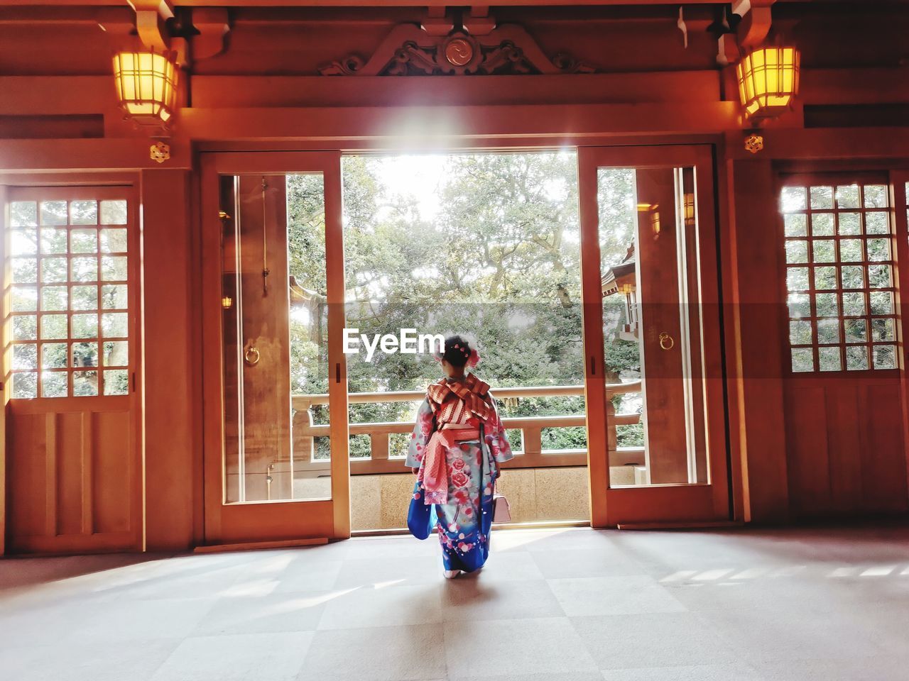 Rear view of girl wearing traditional clothing at temple