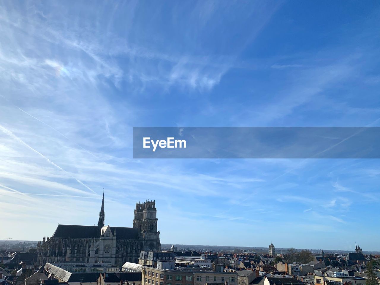 Buildings in city against blue sky