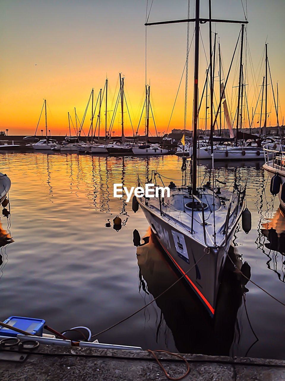 Scenic sunset over sailboats in marina