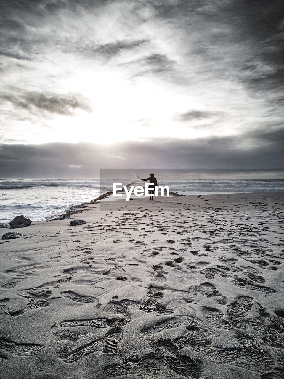 Woman on beach against sky