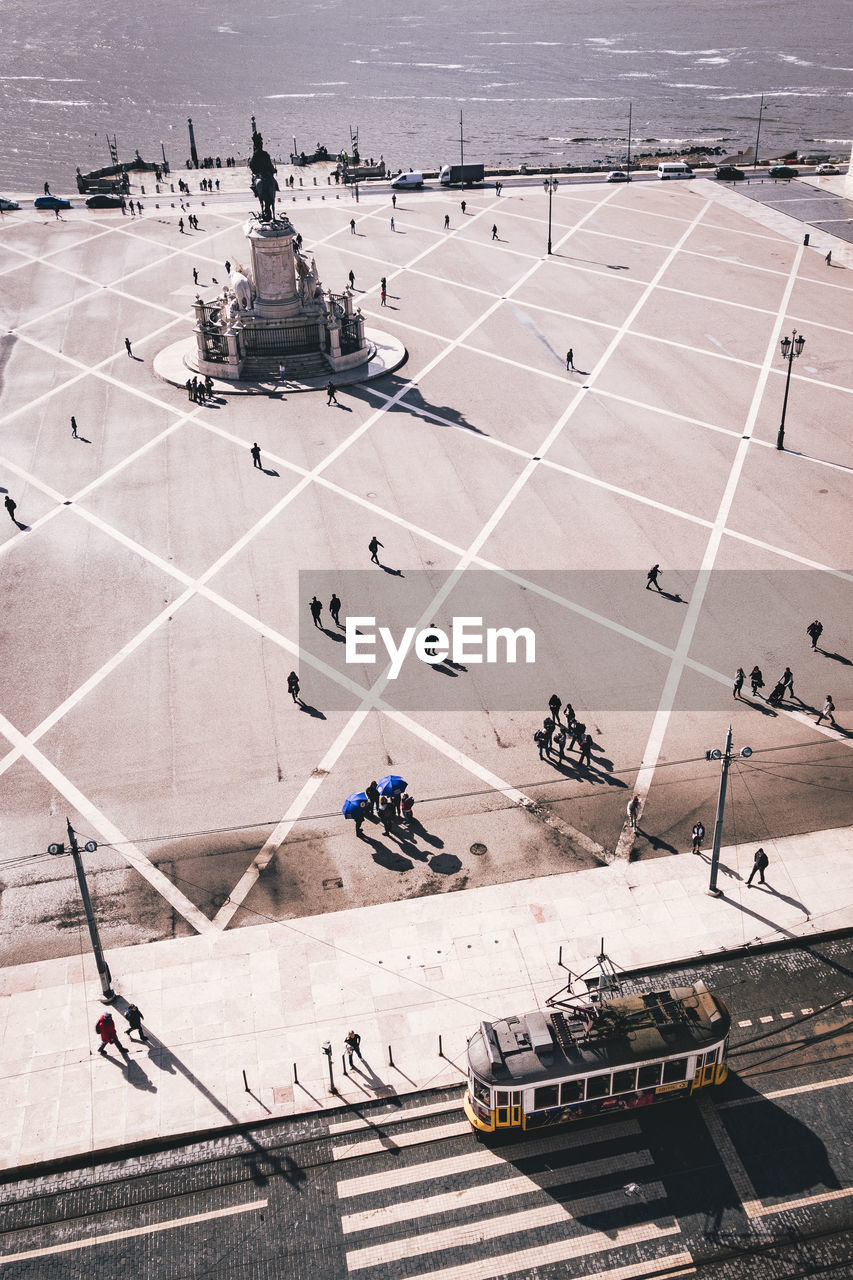 HIGH ANGLE VIEW OF PEOPLE ON ROAD