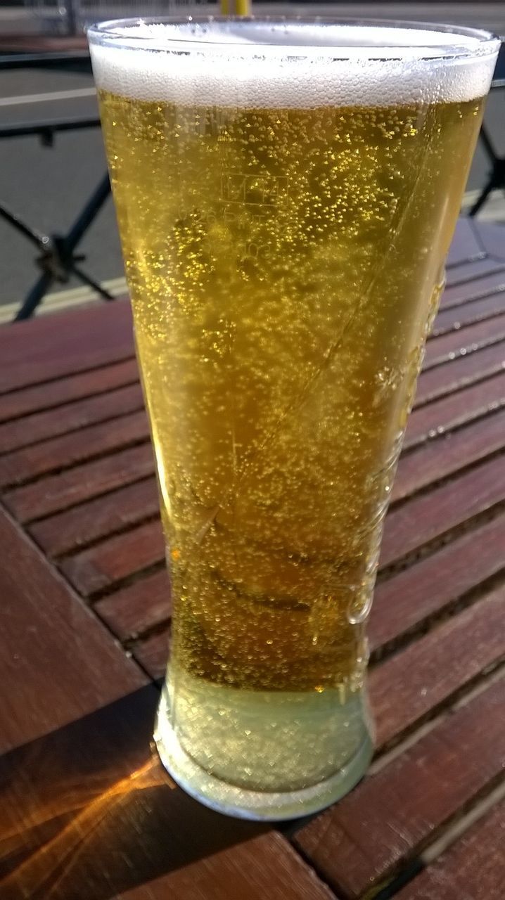 Close-up of beer on wooden table